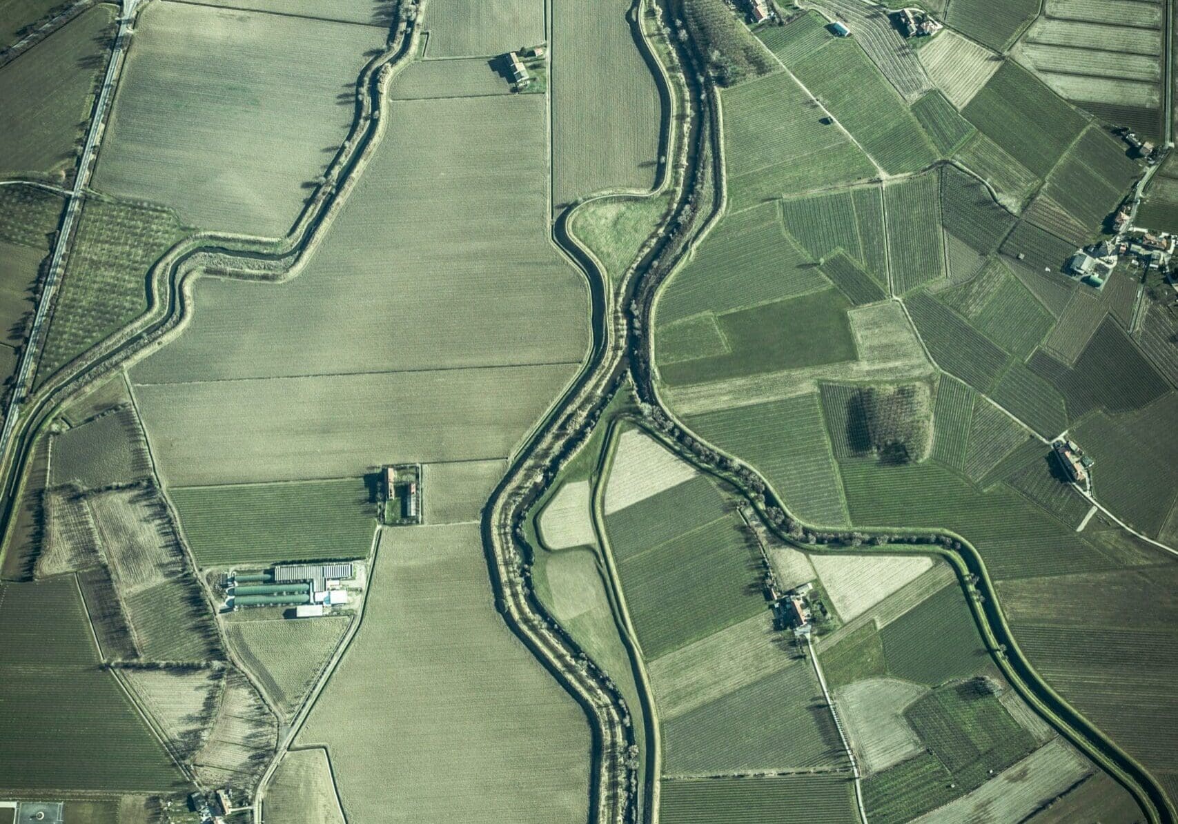 an aerial photo of tidy green agriculture fields